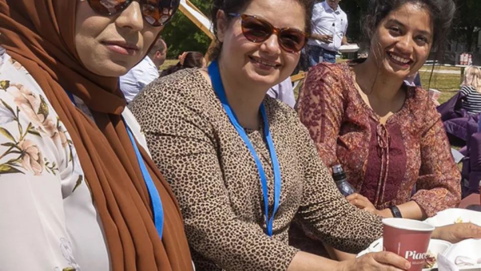 Three women outside smiling