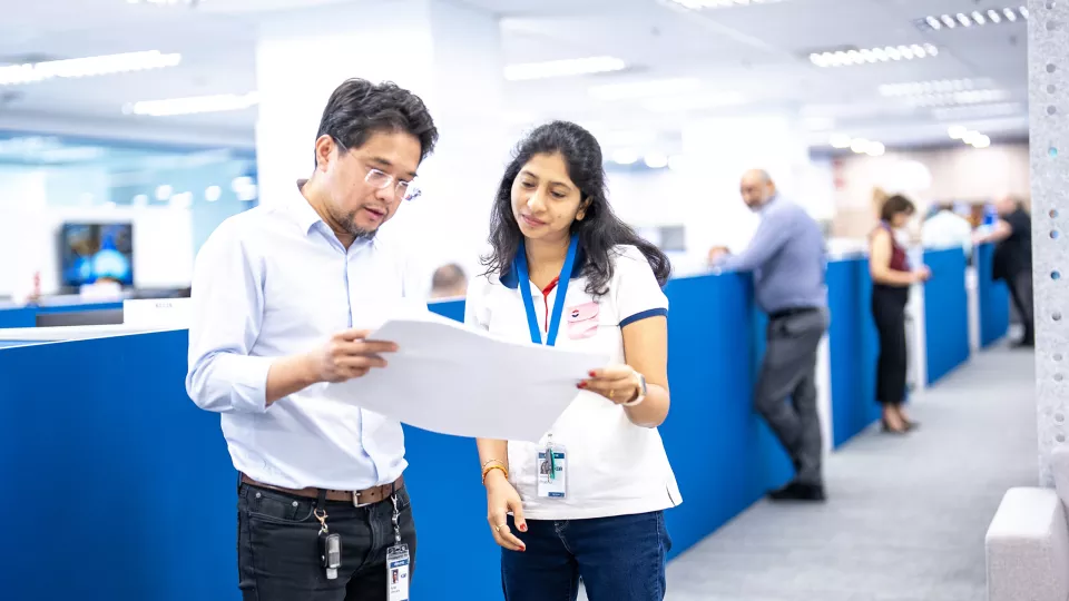 KBR employees reviewing document together