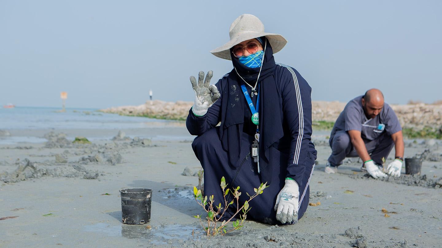 KBR employee finishes planting tree